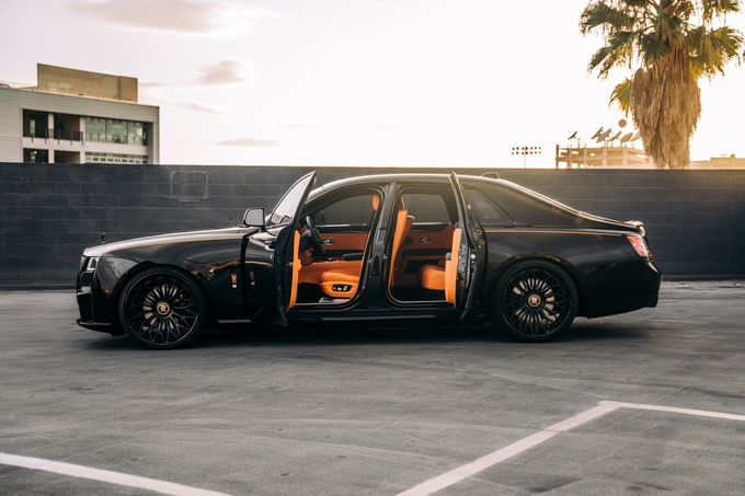Black Rolls Royce Ghost parked showing the drivers side