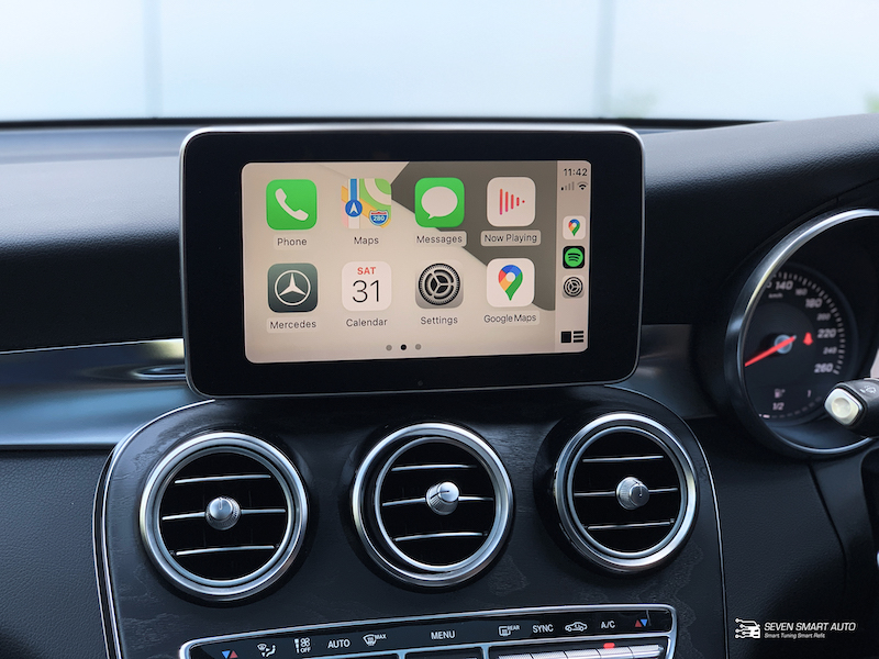 Interior of a car showing a dashboard screen with Apple CarPlay