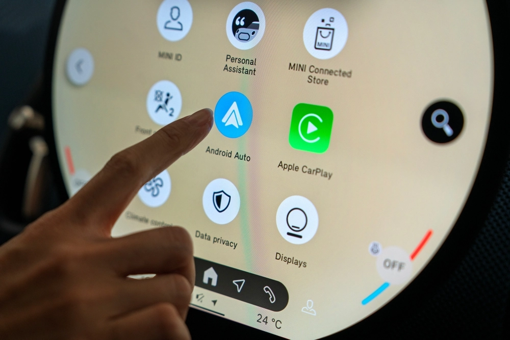 Close-up view of the touchscreen infotainment system, featuring Android Auto and Apple CarPlay icons.